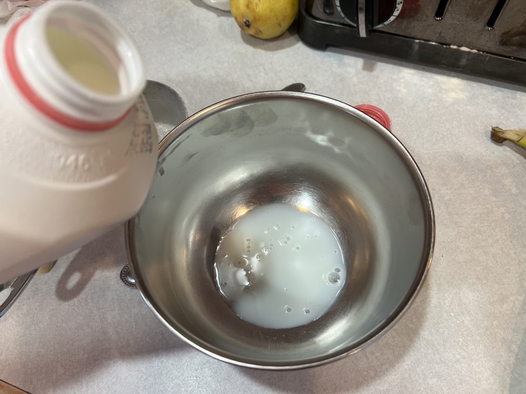 putting a tablespoon of milk into a bowl