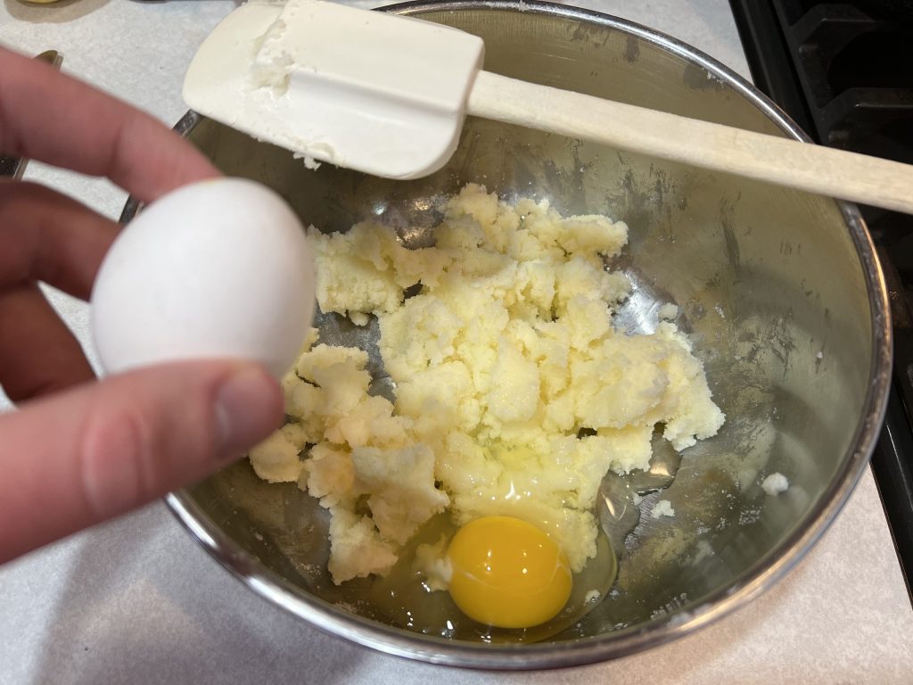 cracking second egg into large bowl