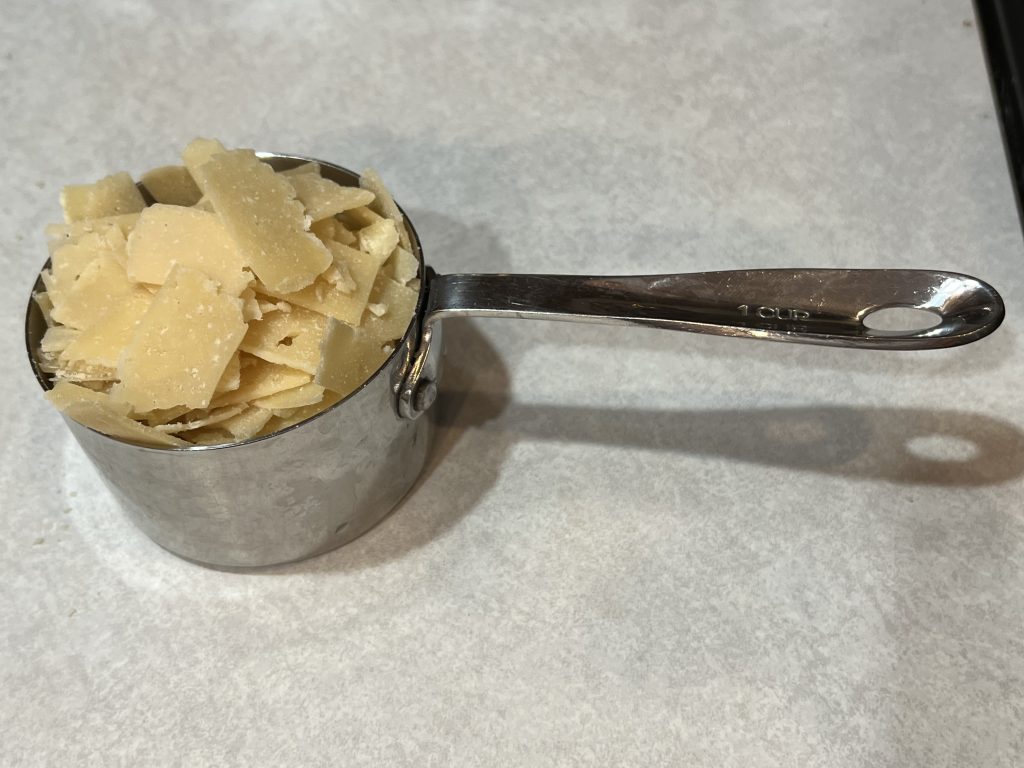 parmesan cheese in a measuring cup for alfredo sauce recipe