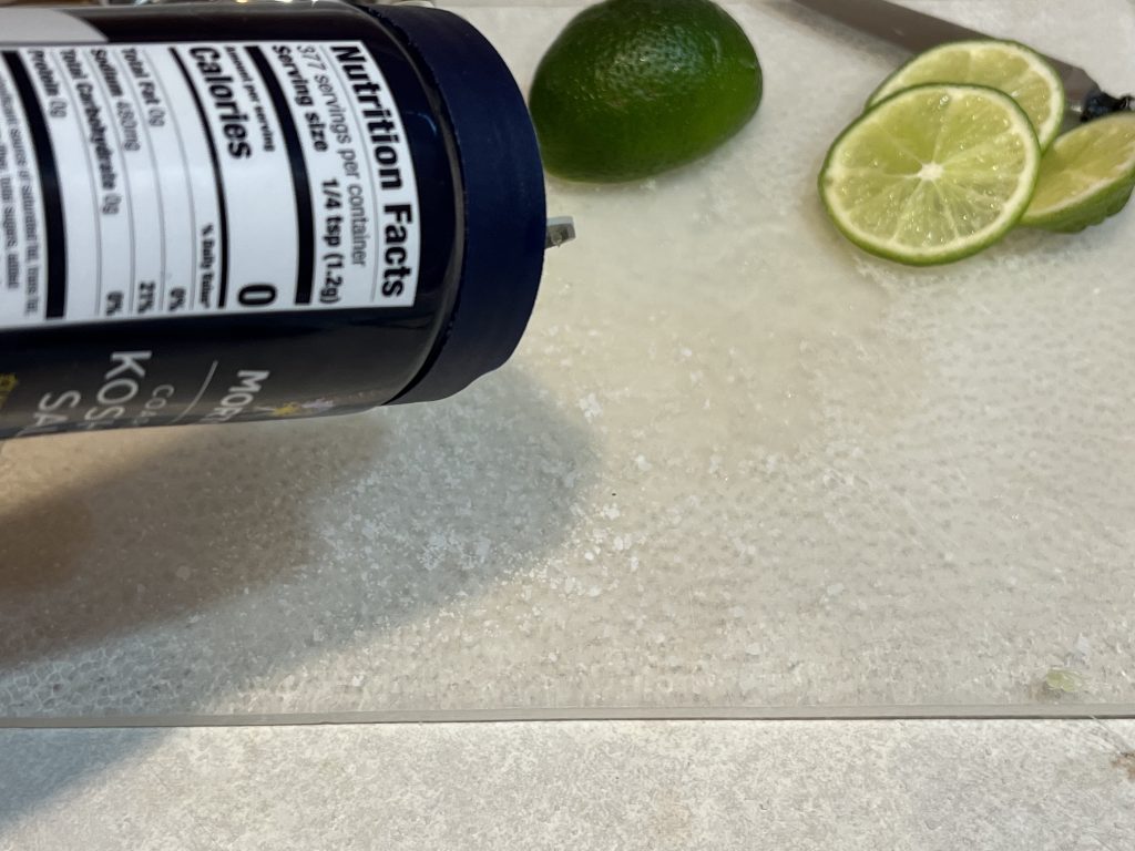 Pouring Kosher salt out on cutting board for margarita recipe