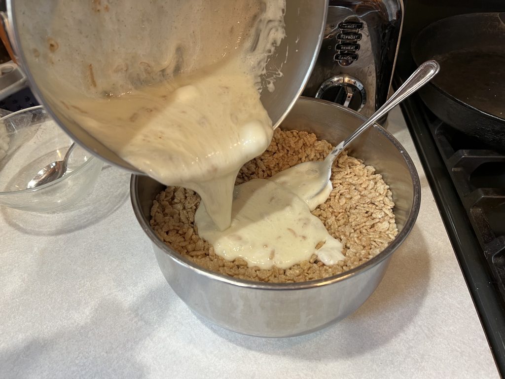pouring rice krispies into saucepan