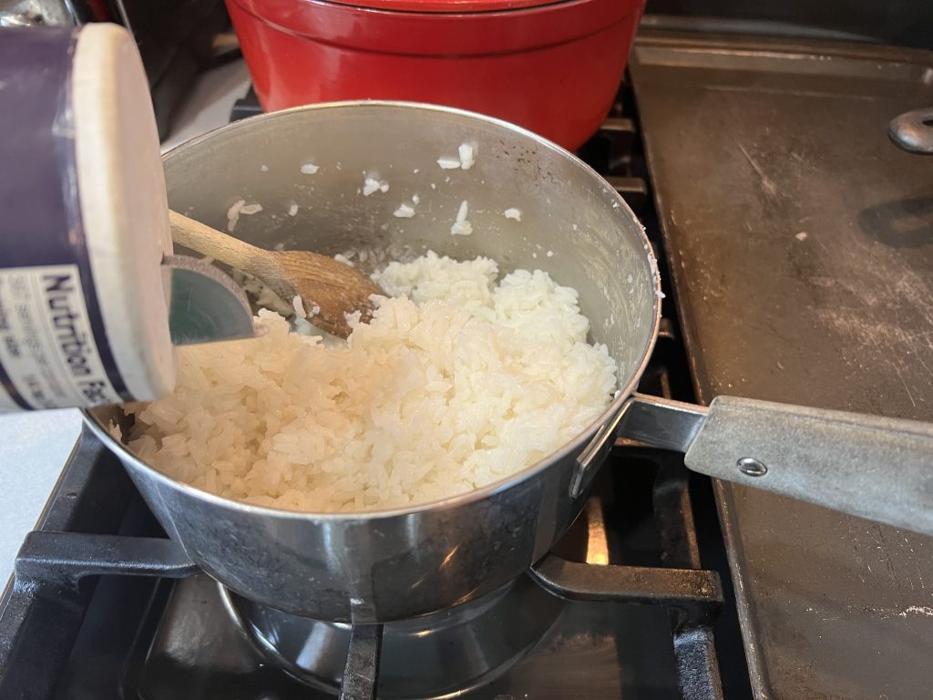 stirring rice and adding salt