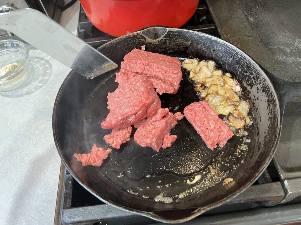 ground beef in skillet for chopped cheese