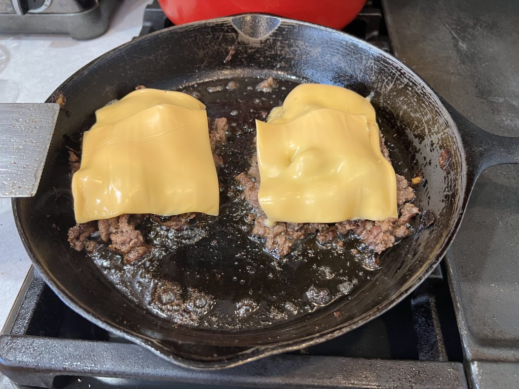 adding cheese to meat