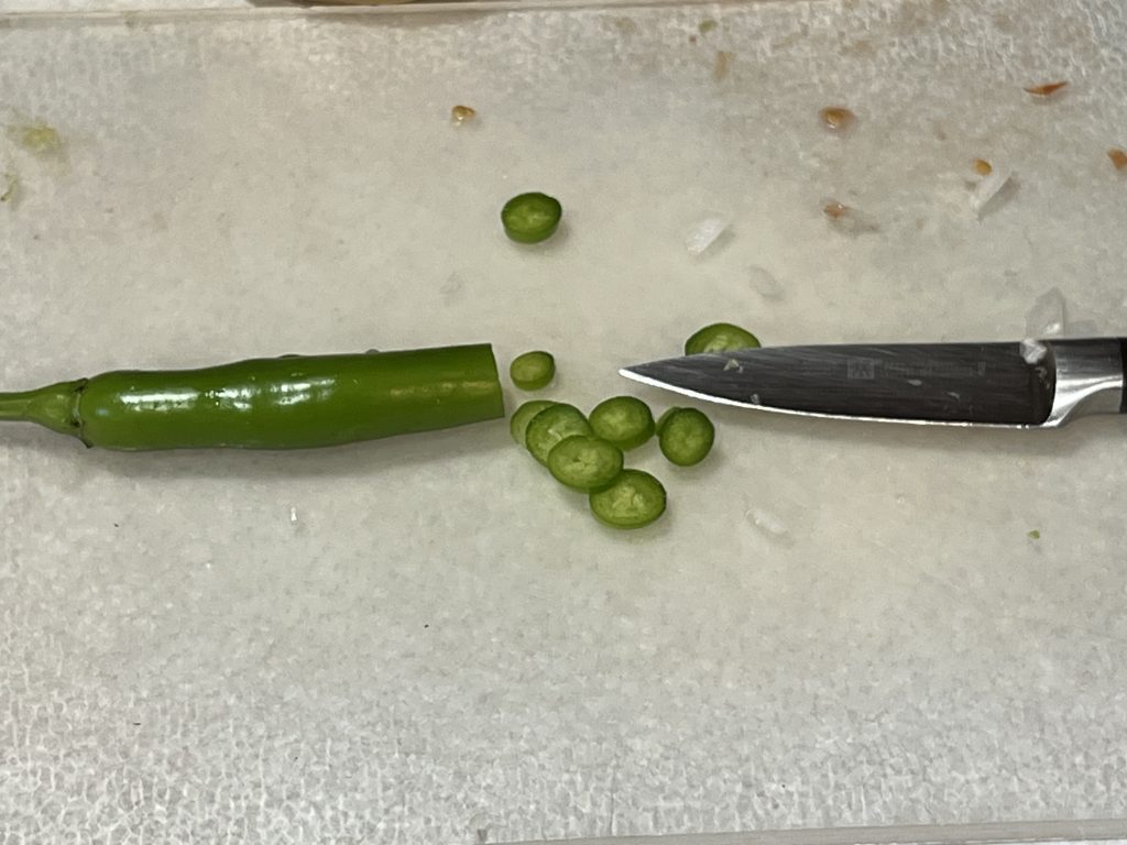 finely chopping up a serrano chile