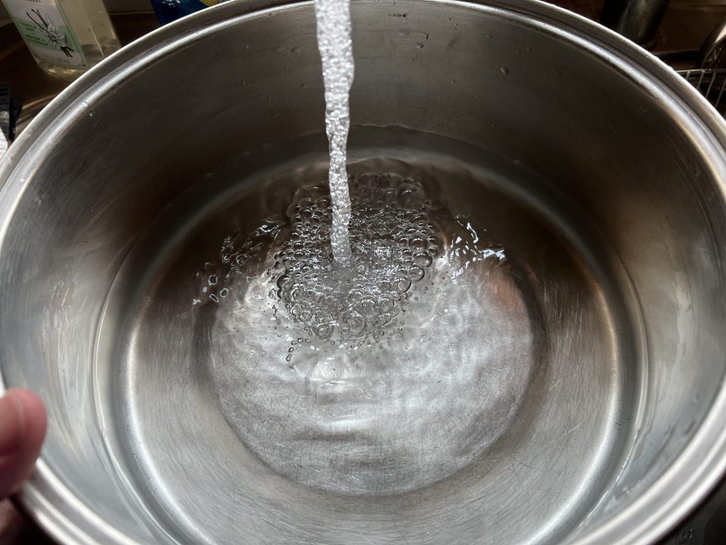 filling large pot of water for cavatappi pasta recipe