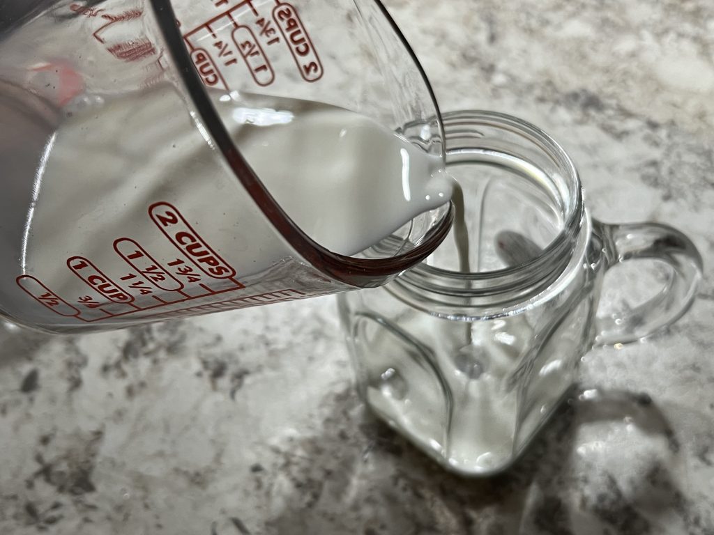 Pouring milk into mason jar