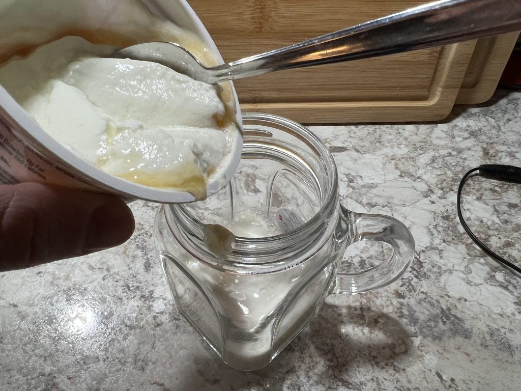 pouring yogurt into mason jar