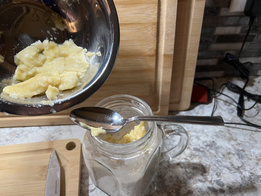 dumping banana into mason jar for overnight oats recipe