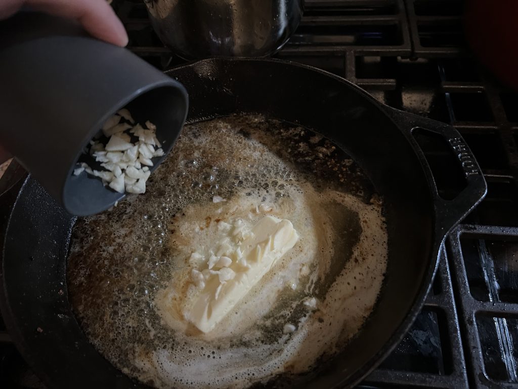 putting garlic in a skillet