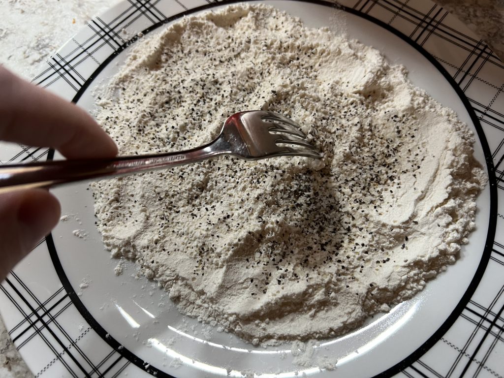 mixing salt, pepper, and flour together