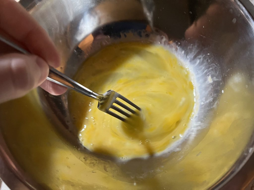 mixing egg around in a medium sized bowl