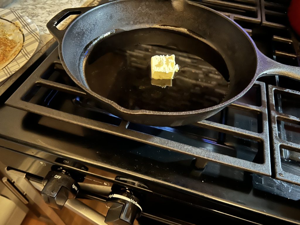 putting 1 tablespoon of 
butter into a skillet