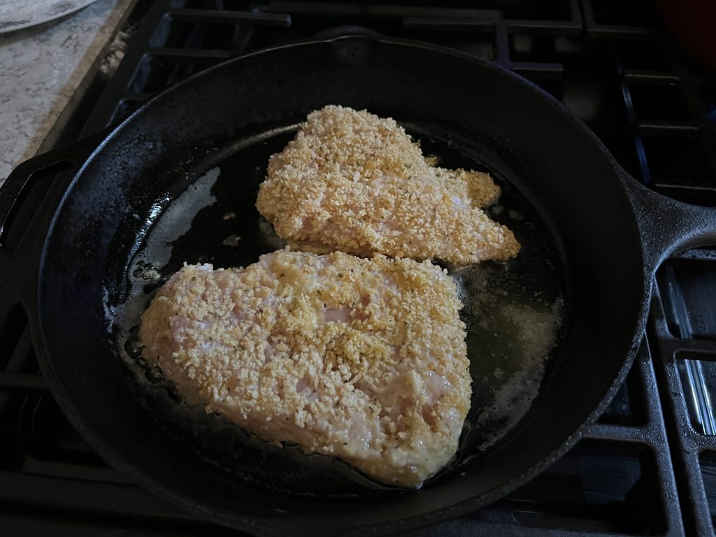 chicken breasts cooking in skillet