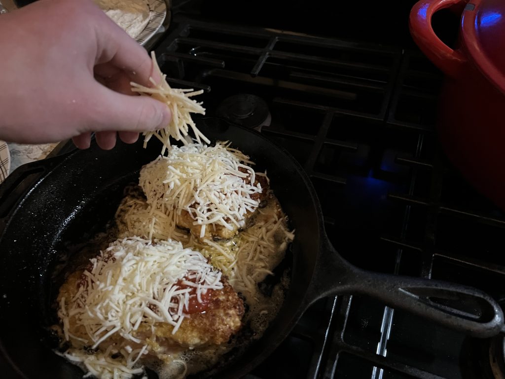 putting mozzarella on chicken breasts